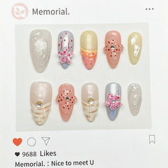 MABKJLF nails showcase rhinestones and pearls for a luxe look.