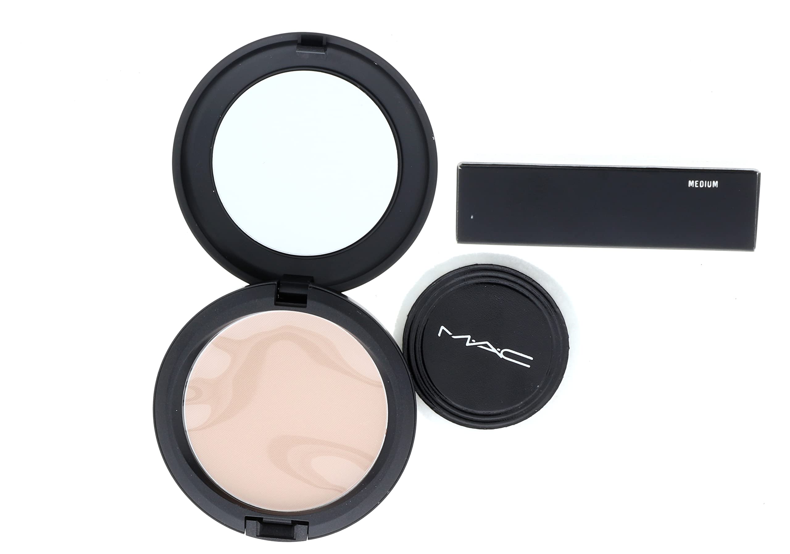 Applying MAC Blot Powder Medium to the T-zone for a matte finish.