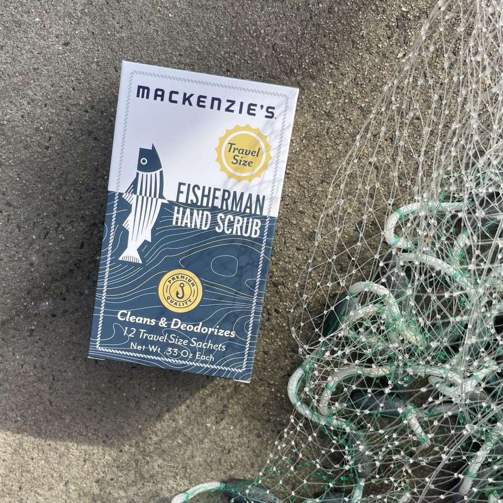 MACKENZIE'S Fisherman Hand Scrub travel packet beside holiday gift box.