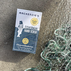 MACKENZIE'S Fisherman Hand Scrub travel packet beside holiday gift box.