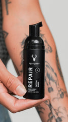 Mad Rabbit piercing and PMU aftercare soap in use, gentle on fresh piercings.