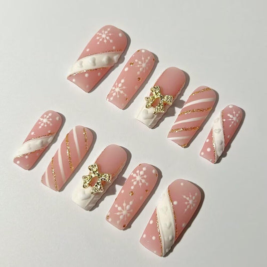 MAGLFELL square nails with snowflake art for a festive at-home manicure.