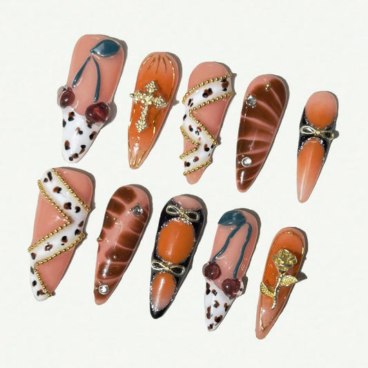 MAGLFELL stiletto orange nails with 3D cherry and gold accents for chic at-home manicures
