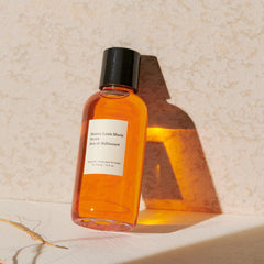 Maison Louis Marie No.04 bottle beside towel for daily self-care ritual.