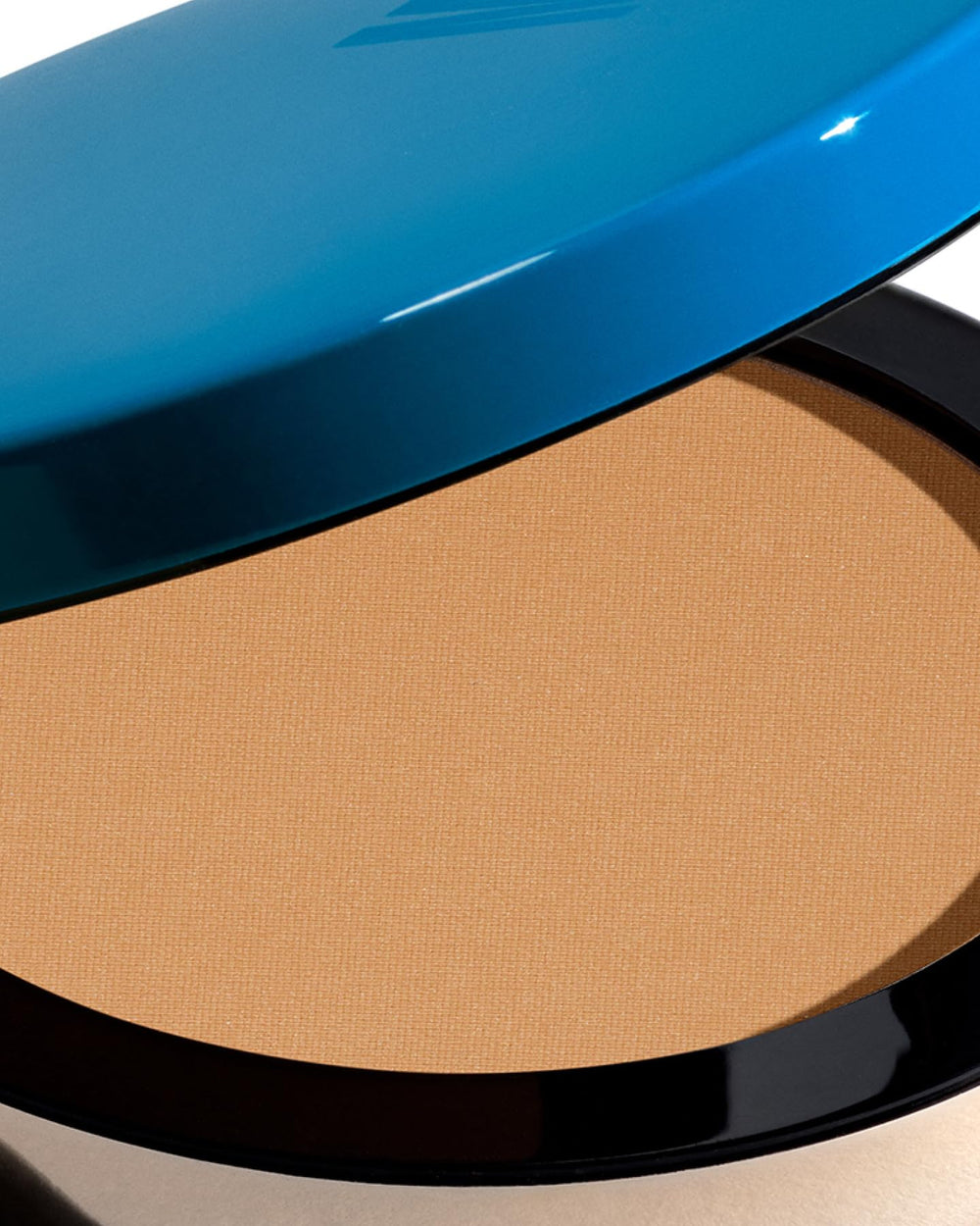 Travel-friendly bronzer compact with refillable pan for easy on-the-go use