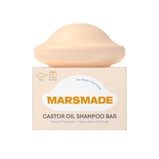 Mars Made Castor Oil Shampoo Bar packaging in focus, bottle-free design.