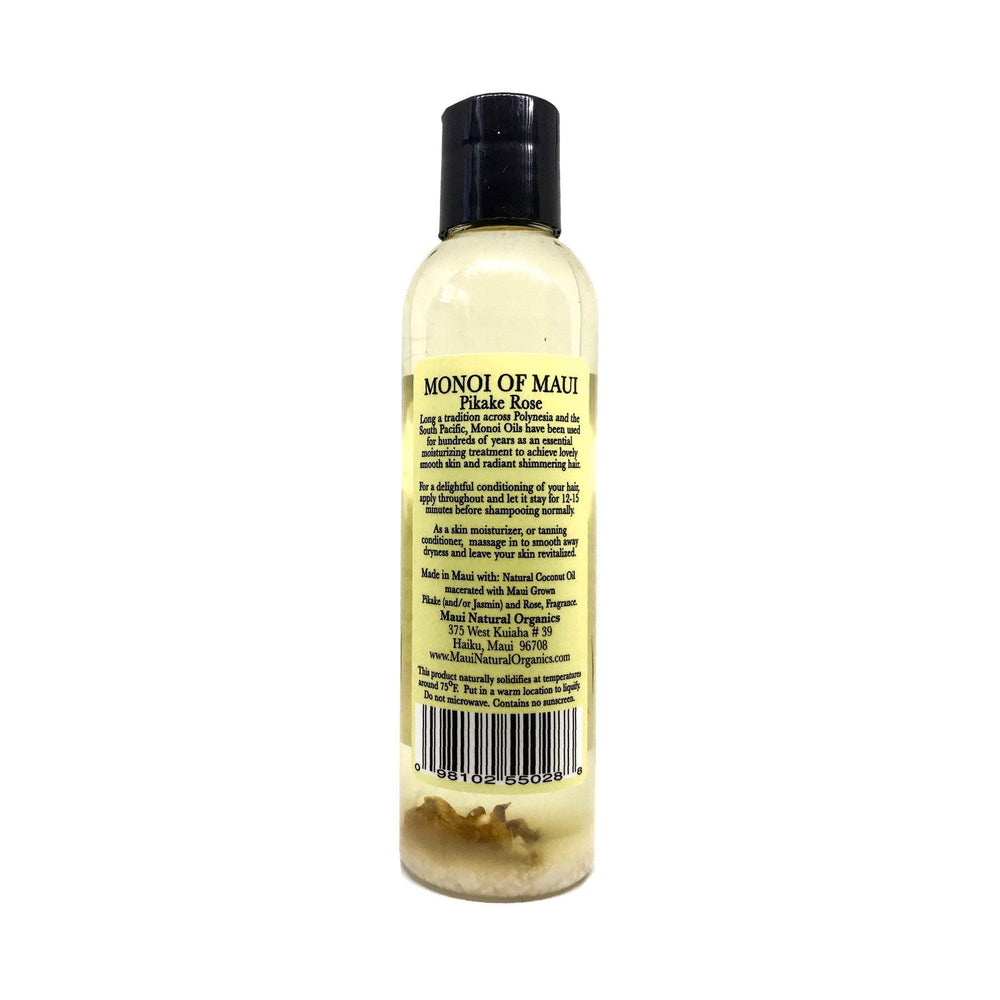 Maui Monoi Pikake Rose Oil being applied to hands for moisturized skin.
