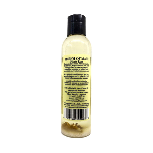 Maui Monoi Pikake Rose Oil being applied to hands for moisturized skin.