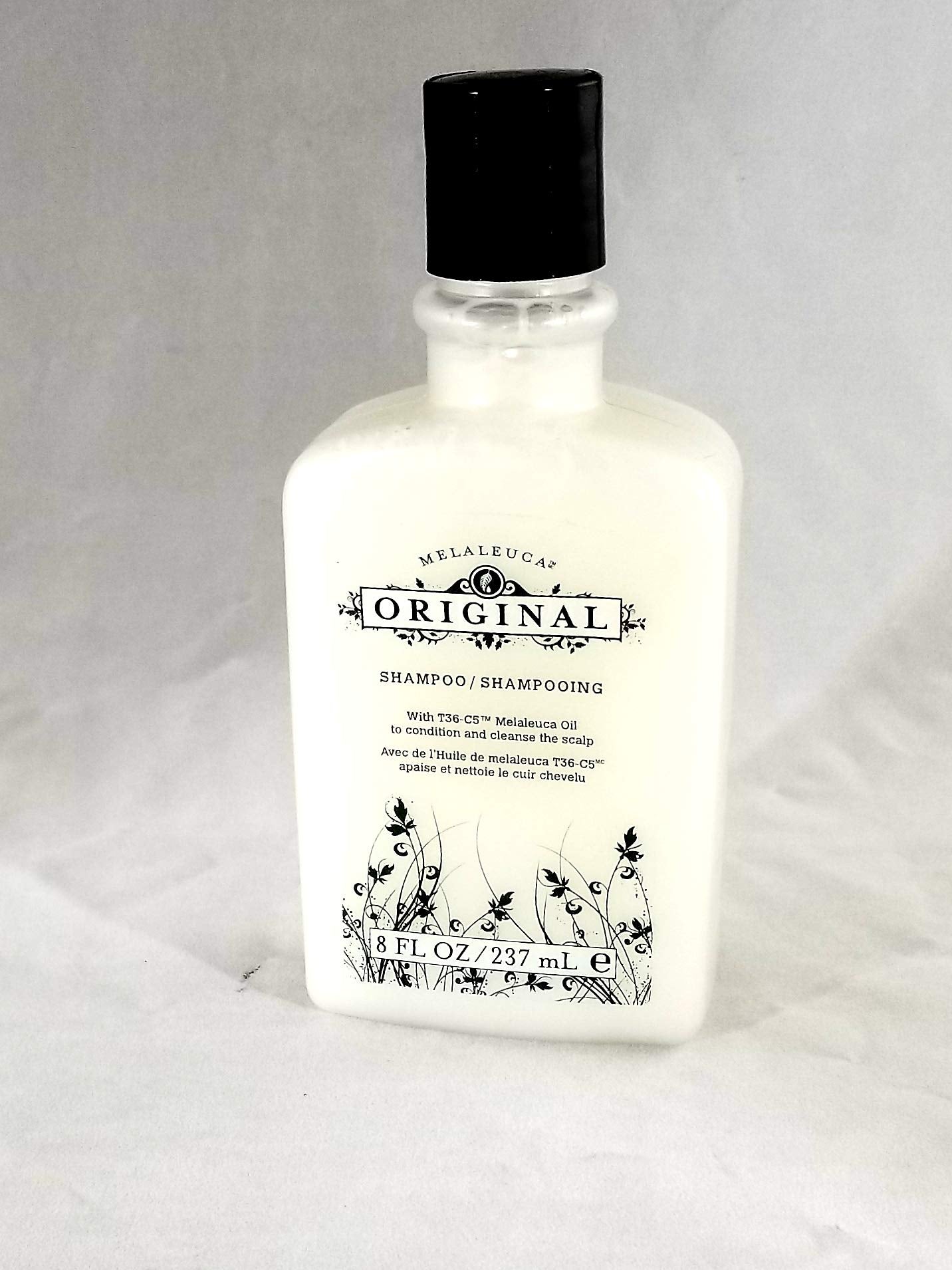 Melaleuca Original Shampoo bottle front showing invigorating herbal scent for daily scalp care.