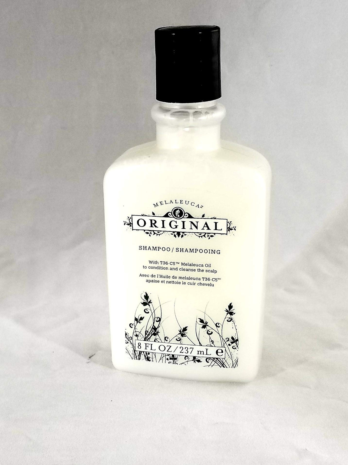 Melaleuca Original Shampoo bottle front showing invigorating herbal scent for daily scalp care.