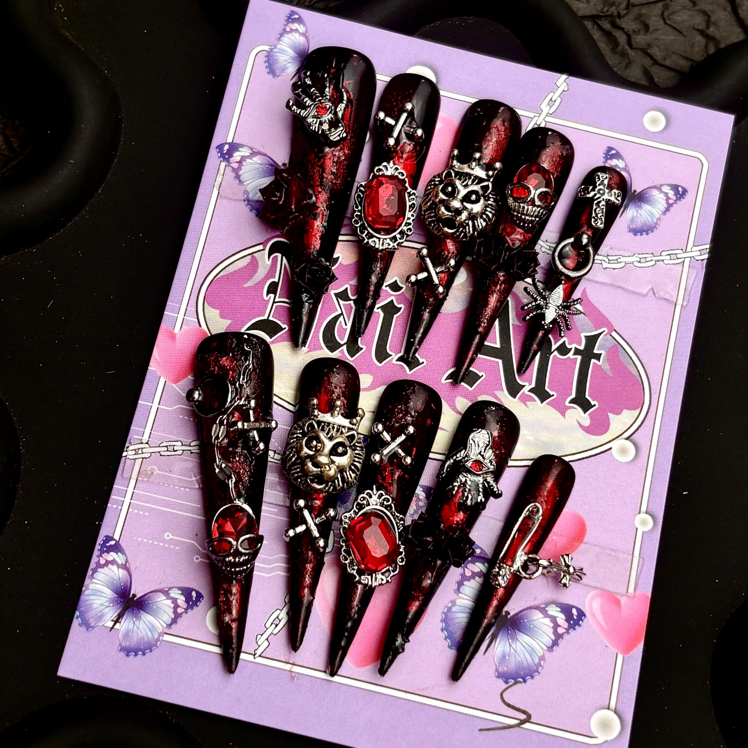MellowBells nails with black floral baroque and chain accents for a bold look