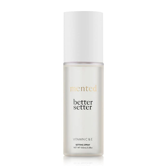 Mented Better Setter spray bottle releasing a fine makeup-setting mist.