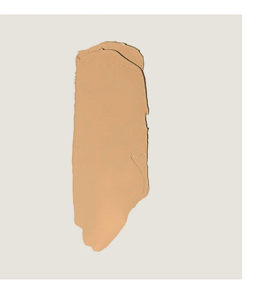 MERIT Camel shade stick applied for easy daily touch-ups and medium coverage.