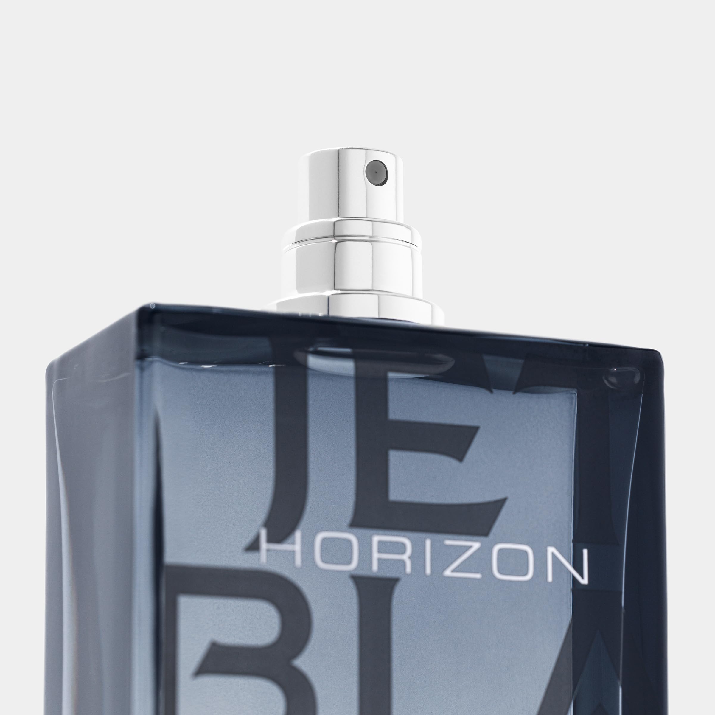 Michael Malul Jet Black Horizon bottle on a reflective surface.