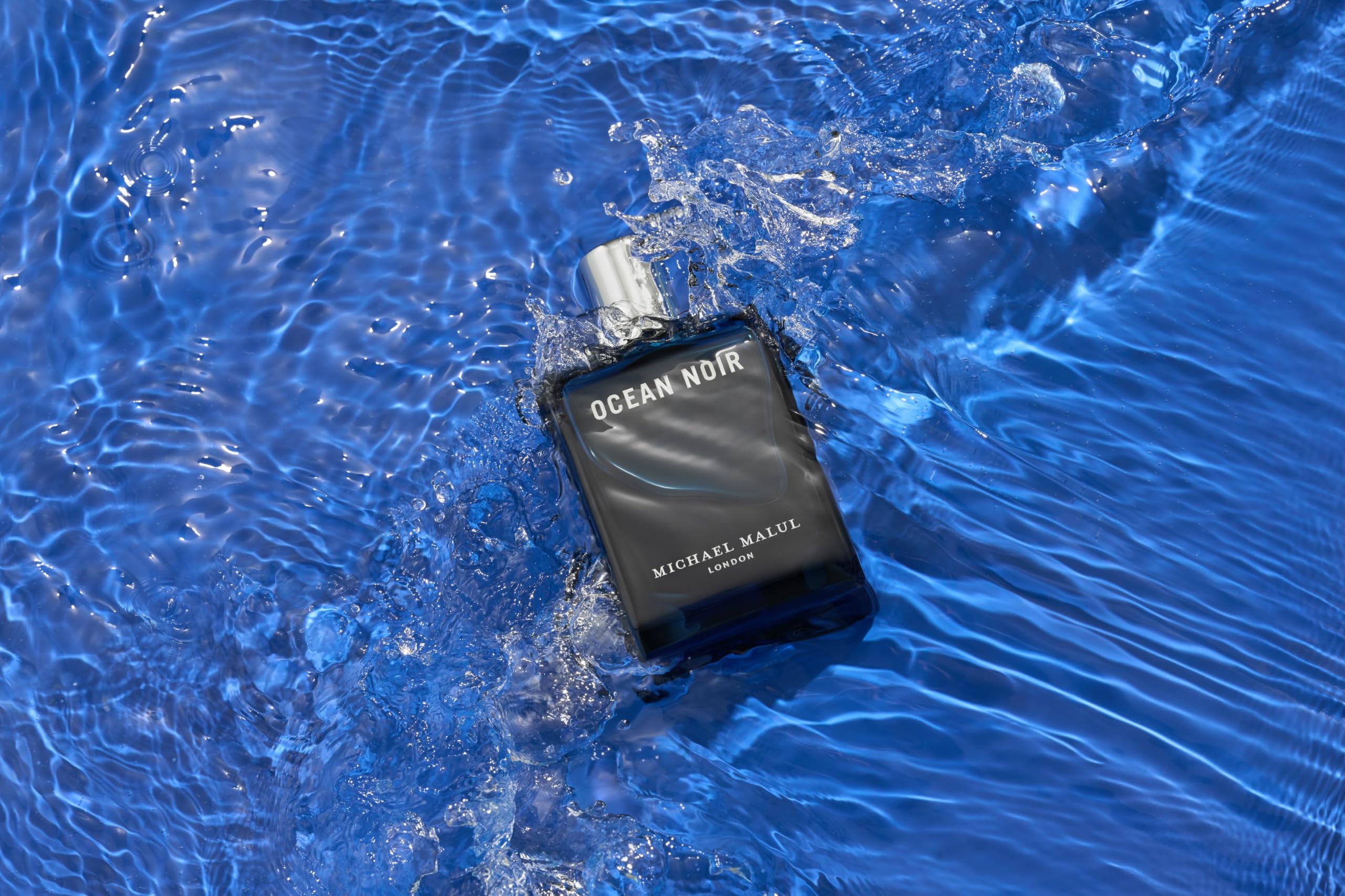 Close-up of Ocean Noir travel spray showing amberwood and musk hints.