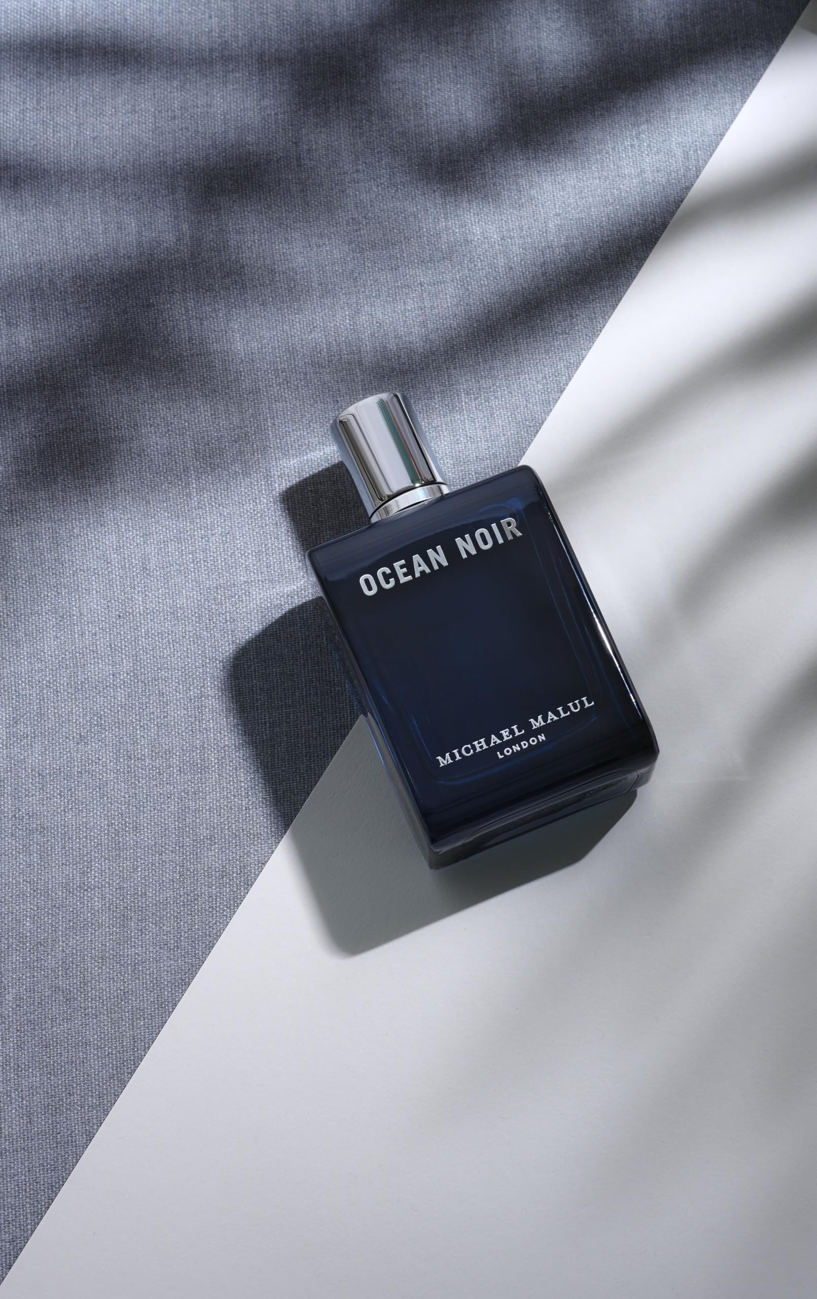 Ocean Noir 100ml bottle with ocean backdrop suggesting coastal freshness.
