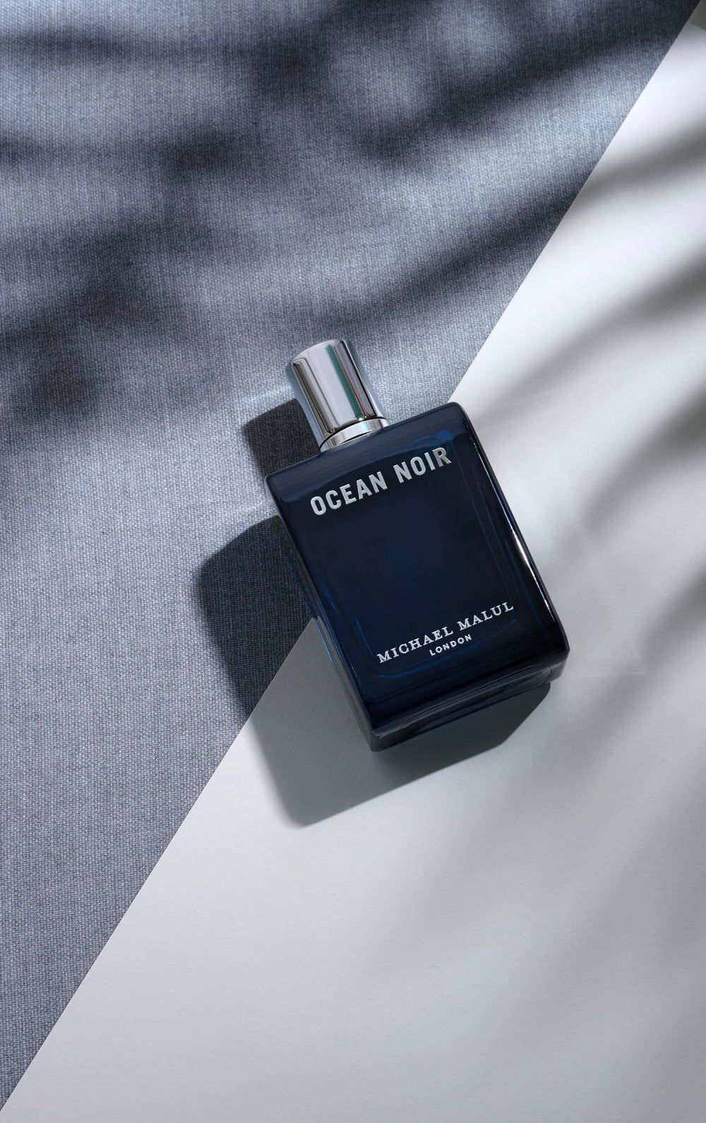 Ocean Noir 100ml bottle with ocean backdrop suggesting coastal freshness.