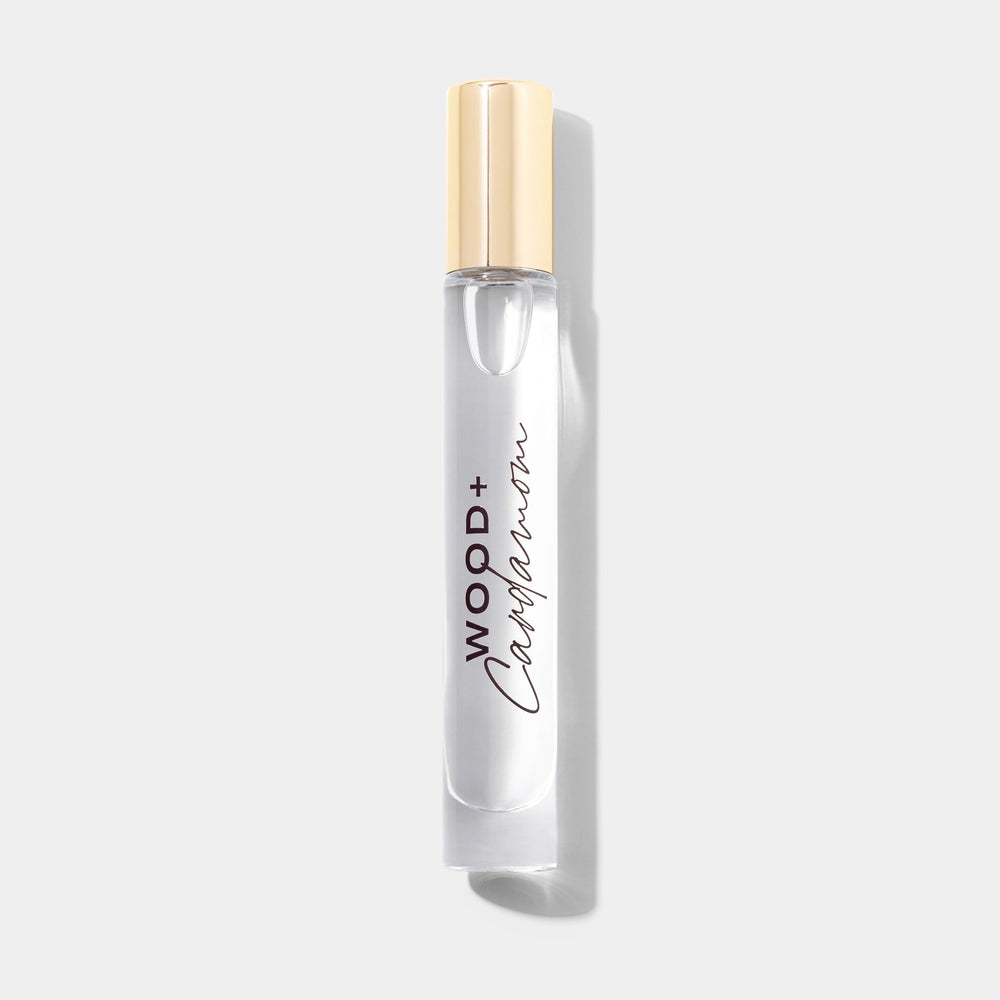 Close-up of Michael Malul Wood + Cardamom bottle with warm tones.