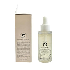 Close-up of MIDHA Rice Facial Oil texture absorbing quickly.