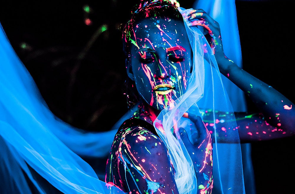 Midnight Glo pink UV neon paint enhances festival makeup under UV light.