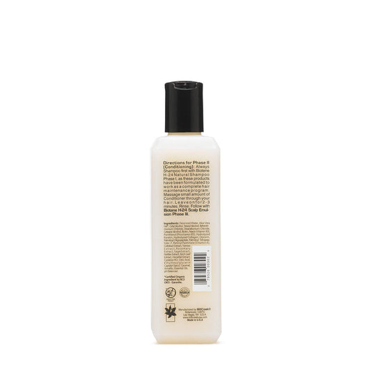 Mill Creek Biotin H24 conditioner tube close-up highlighting rich texture.