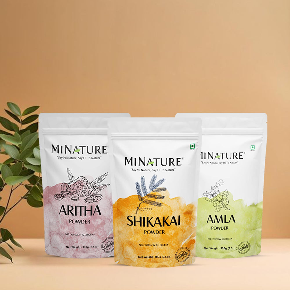Minature hair care routine setup with bowls and powders.