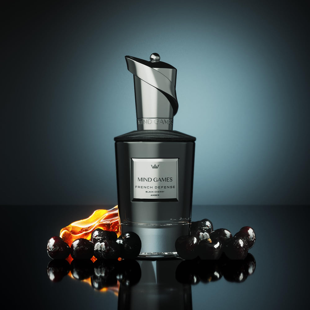 Close-up of amber and cedarwood in MIND GAMES French Defense for a warm, lasting dry-down.