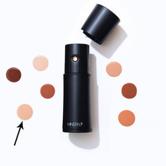 Close-up of Mineral Air Mist Device beside foundation for seamless application.