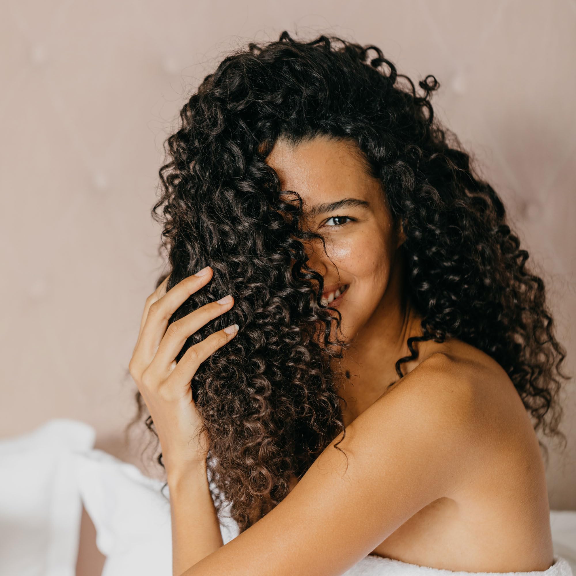 Mirta De Perales Curls Defining Cream being applied to damp hair for smooth definition