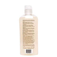 Hands applying Mixed Chicks Serum for heat protection during styling.