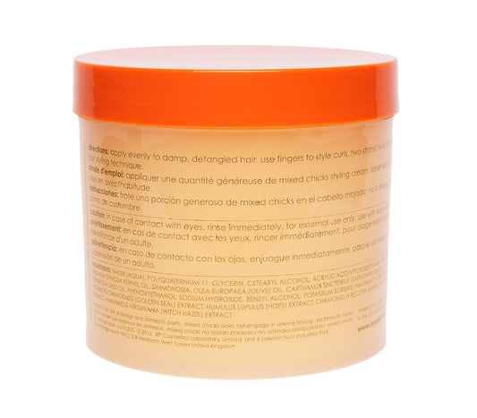 Close-up of Mixed Chicks styling cream being dispensed for wash-and-go styling.