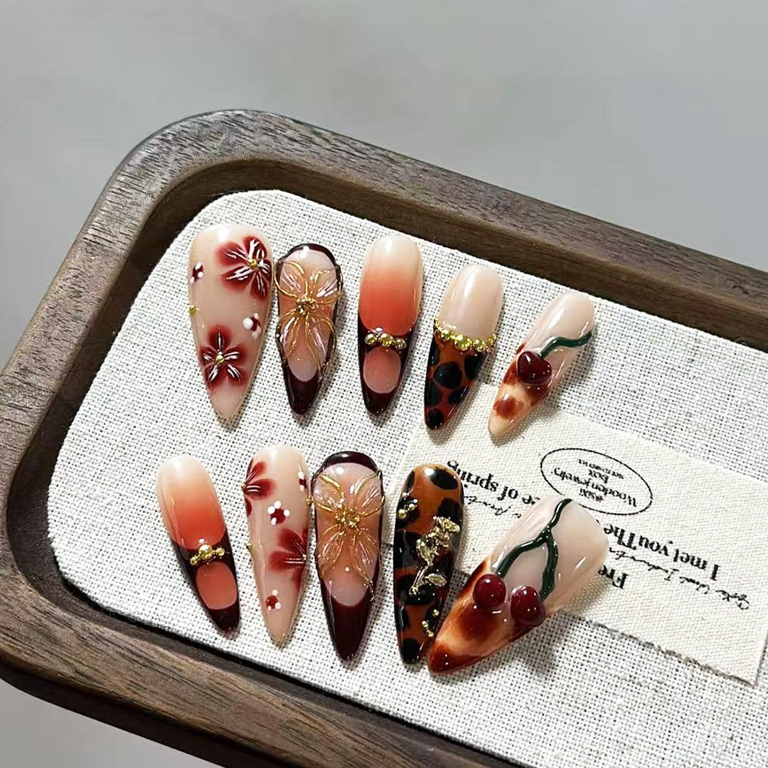 MIXFOSAHN nails with cherry rhinestone accents for sparkle.