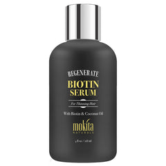 Mokita Naturals Hair Growth Serum bottle close-up highlighting paraben-free biotin for healthier-looking hair.