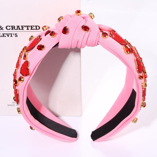 MOLOCH crystal pink top knot headband adds subtle sparkle