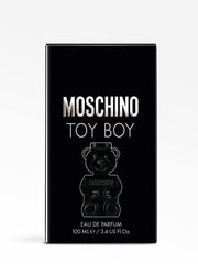 Moschino Toy Boy cap and label close-up, suggesting luxury packaging.