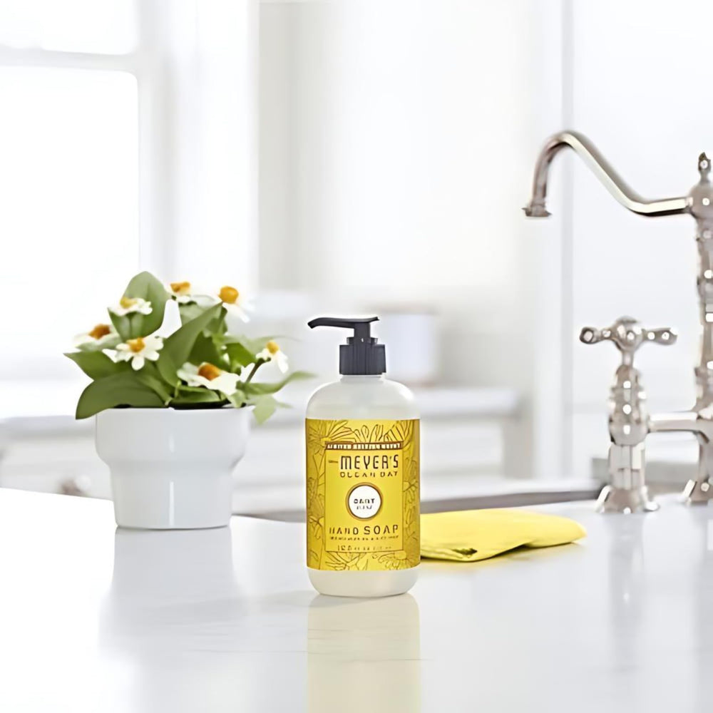 Daisy bottle on sink beside clean dishes for reference