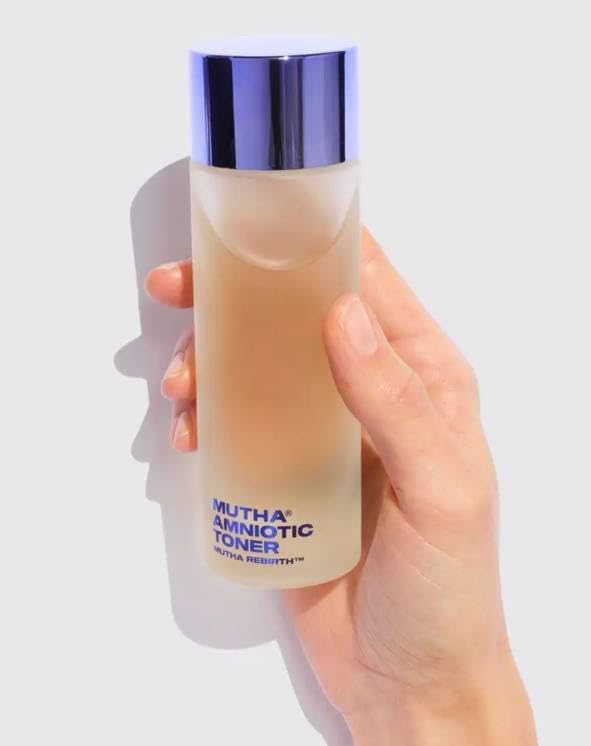 MUTHA Rebirth Amniotic Toner bottle beside towels for daily hydrating routine.