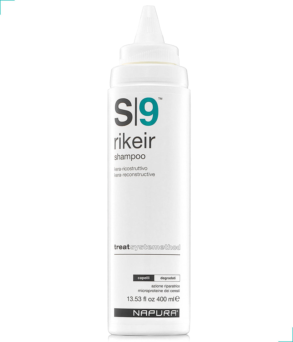 NAPURA S9 shampoo bottle on a shower shelf, color-safe care for damaged hair.
