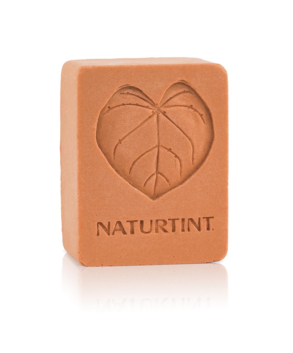 Naturtint shampoo bar orange close-up with creamy lather suggests gentle cleansing.
