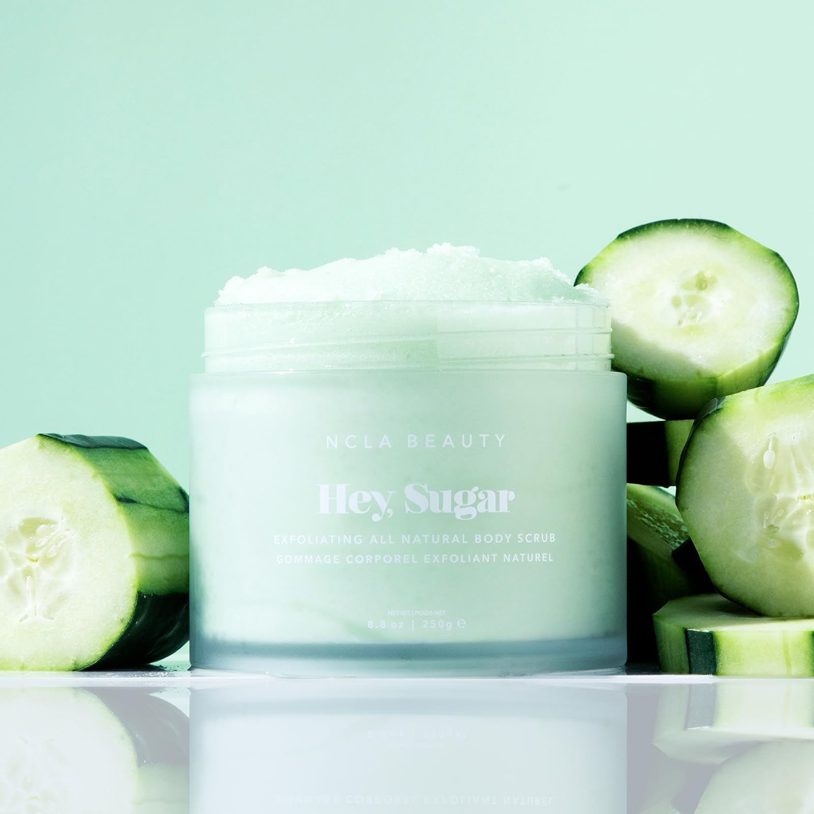 NCLA Beauty Hey Sugar exfoliating sugar particles indicating gentle dead skin removal.