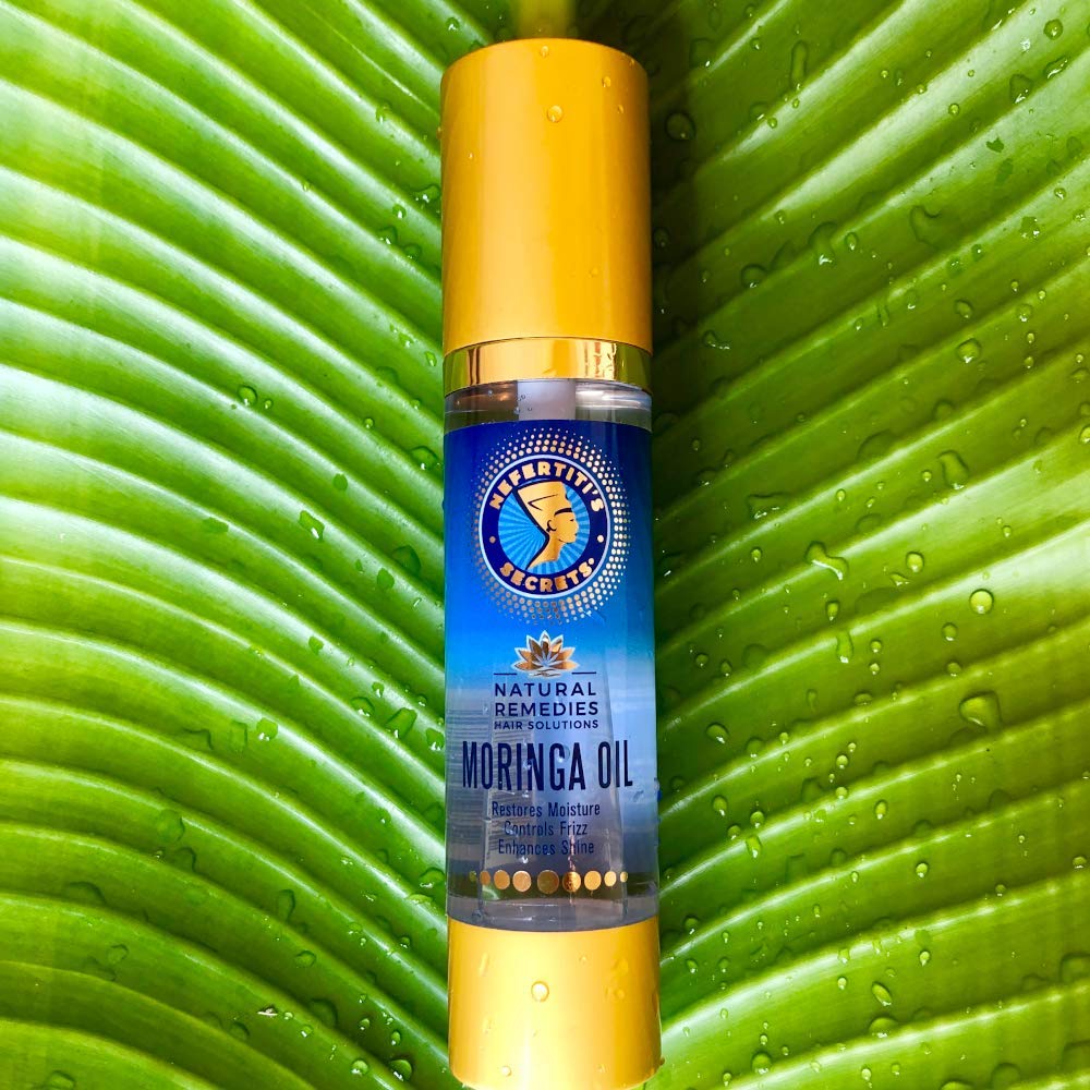 Nefertiti's Secrets application dropper shows easy, precise hair treatment.