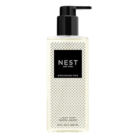 NEST New York Birchwood Pine liquid soap bottle pouring, delivering clean hands with subtle, aromatic notes.