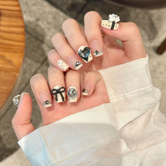 NLSJMP nails with a black bow accent for stylish evening outfits.