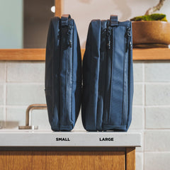 NOMATIC bag with multiple compartments keeps shaving kit and toiletries neatly separated.