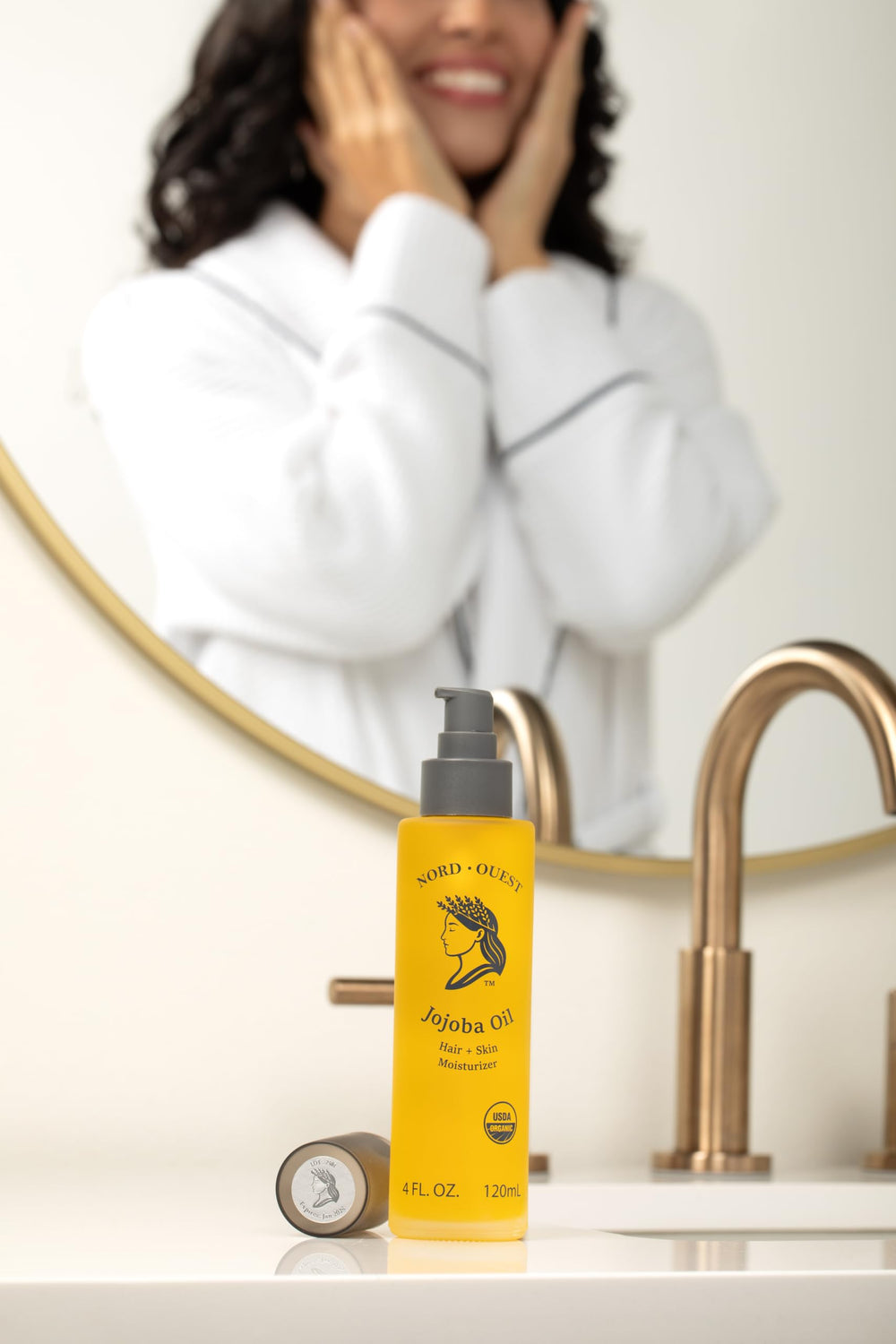 Pouring jojoba oil highlights lightweight, non-greasy hydration for skin and hair