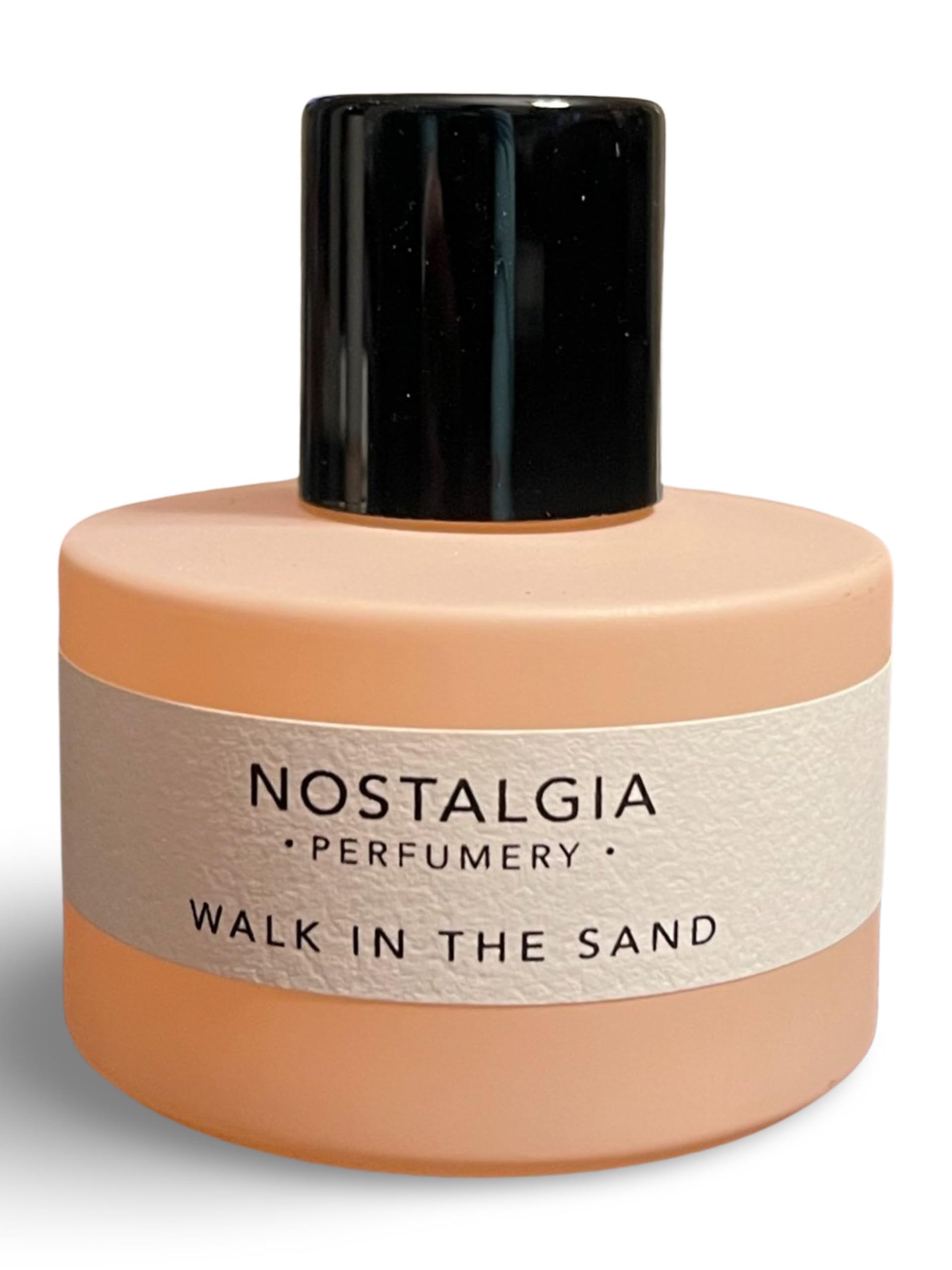 Close-up of Nostalgia Perfumery Walk in the Sand cap on a round bottle