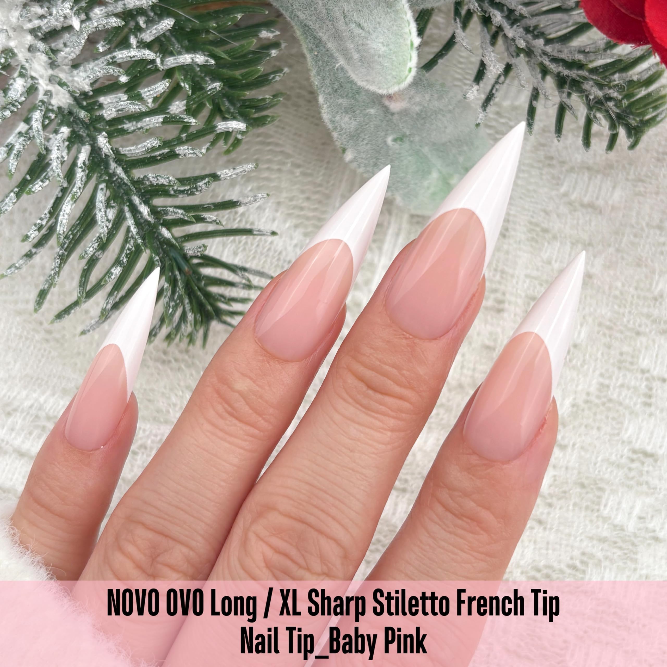 NOVO OVO white French tip long XL sharp stiletto nails in baby pink shown from a different angle.