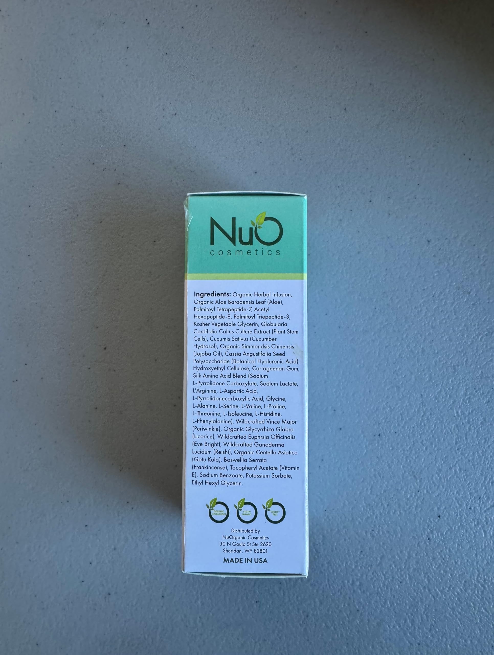 NuOrganic Perfect Eye Serum USA-made lab production seal shows quality control.