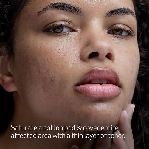 Obagi CLENZIderm MD toner on cotton pad, aiding pore unclogging.