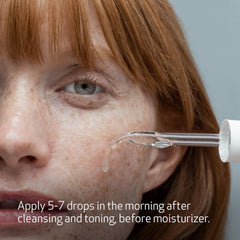 Serum being applied to the cheek as part of a routine.